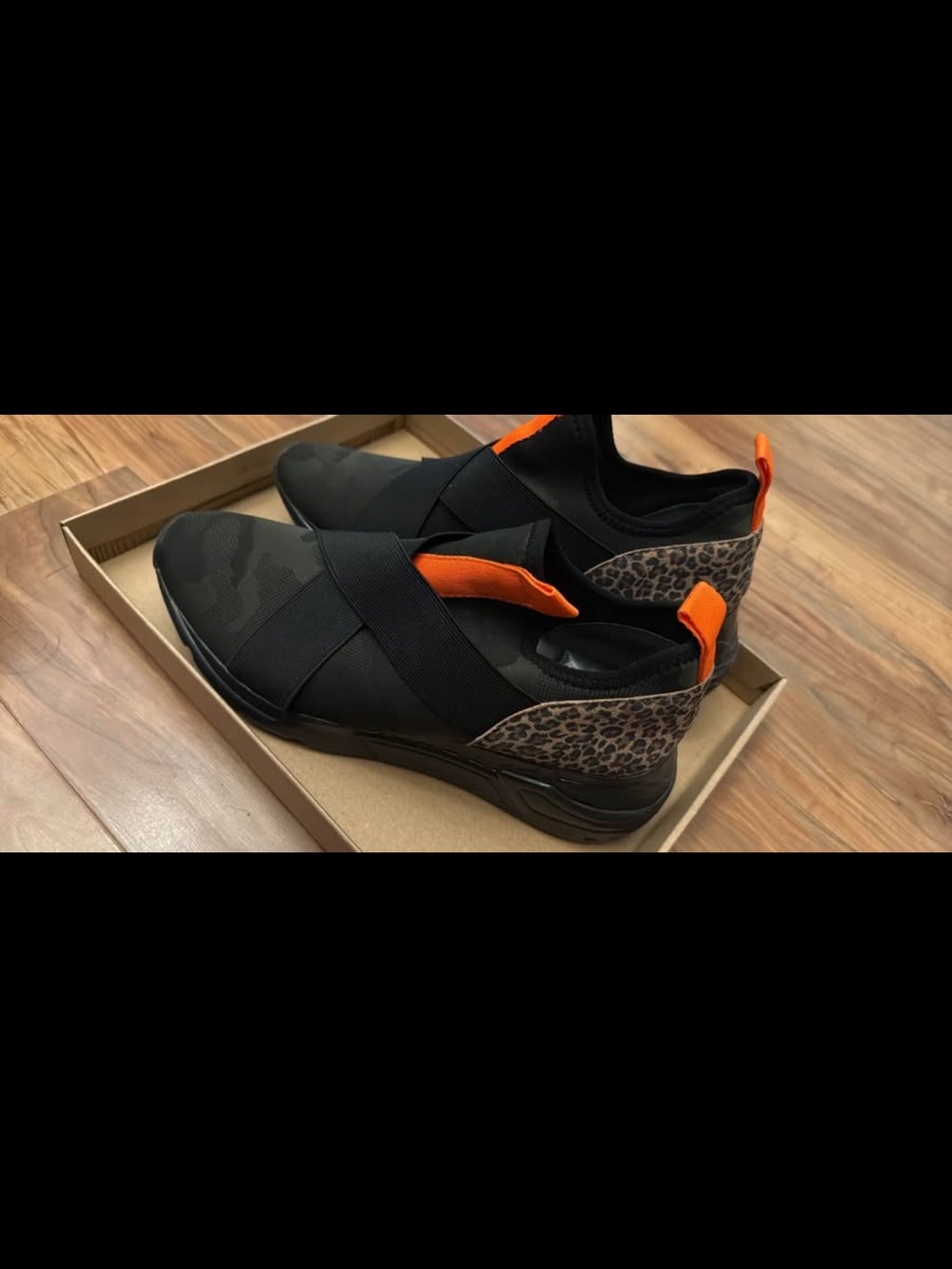 Steve Madden Black Slip-On Sneakers with Orange Pull Tabs and Leopard Heel